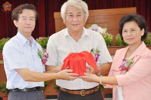 金門農工新任校長劉湘金(右)自卸任校長陳水芳(左)手中接過印信,由陳樹華監交。(張建騰攝)