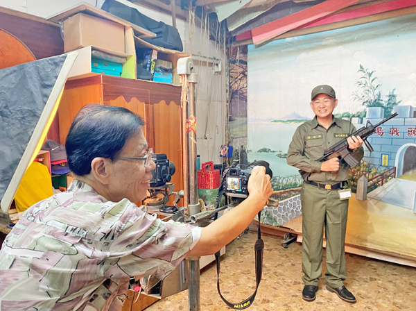 縣長楊鎮浯換上草綠服軍裝,模擬當年阿兵哥必拍的紀念照。(陳冠霖攝)