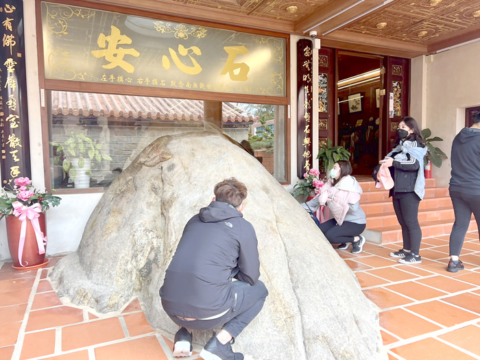 民眾手摸海印寺「安心石」,希望讓心能夠安定下來。(民眾提供)