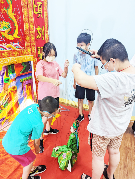 金門家扶中心暑期課業輔導班安排傀儡戲體驗活動，引領兒童認識傳統文化。（李增汪攝）