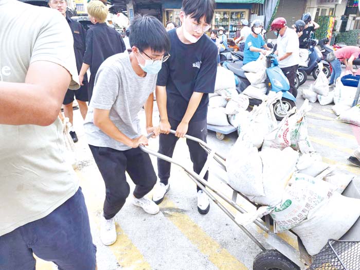 民眾準備手推車,載運沙包。(許峻魁攝)