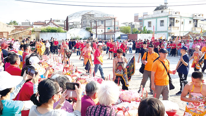 沙美萬安堂三忠廟一連三天舉辦建醮祈福慶典，第二日下午出社、鎮五方、吃三牲粿科儀最為熱鬧，來自台金兩地的廟宇、神輦、乩身、信眾等齊參與，隊伍所到之處鞭炮轟隆炸響，各家戶設香案，備三牲粿品拜拜祈福。（陳麗妤攝）