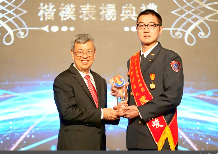 行政院長陳建仁與消防楷模鳳凰獎得主陳佳峻合影。(消防局提供)