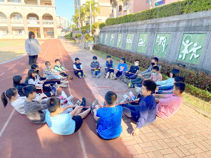 金門大學敏捷攀樹社攜手上杉夏海專業團隊前進湖埔國小、正義國小校園推廣本然教育活動,小朋友體驗攀樹樂趣以及參與遊戲。(金門大學敏捷攀樹社提供)