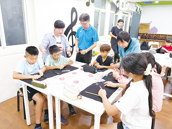 講師帶領安瀾國小學生親手將高粱桿轉化為書畫工具，校長陳來添全程陪同參與。	（安瀾國小提供）