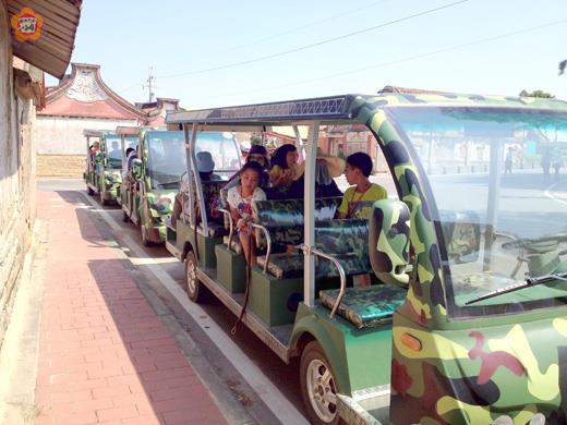  環保局「2014金門低碳島‧樂活FUN心行」活動昨日正式開跑，總共吸引30位親子旅客一同參與，搭乘電瓶車遊覽古寧頭週邊景點，體驗歷史戰役的遺跡並合照。（環保局提供）