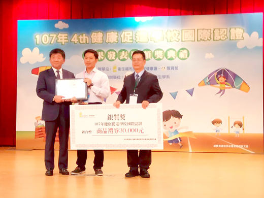 衛福部部長陳時中頒發銀質獎牌予賢庵國小。(賢庵國小提供)