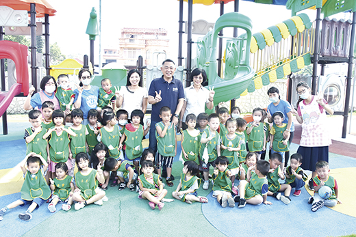 縣長視察戶外遊樂場設施，並與幼生合影。（李金鎗攝）