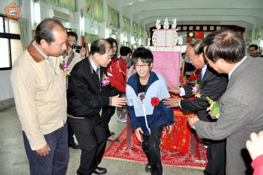 烈嶼鄉成年禮昨舉行,鑽七娘媽亭腳,縣長李沃士和鄉長洪成發牽引行成年禮學生,祝福他們成年。(楊水詠攝)